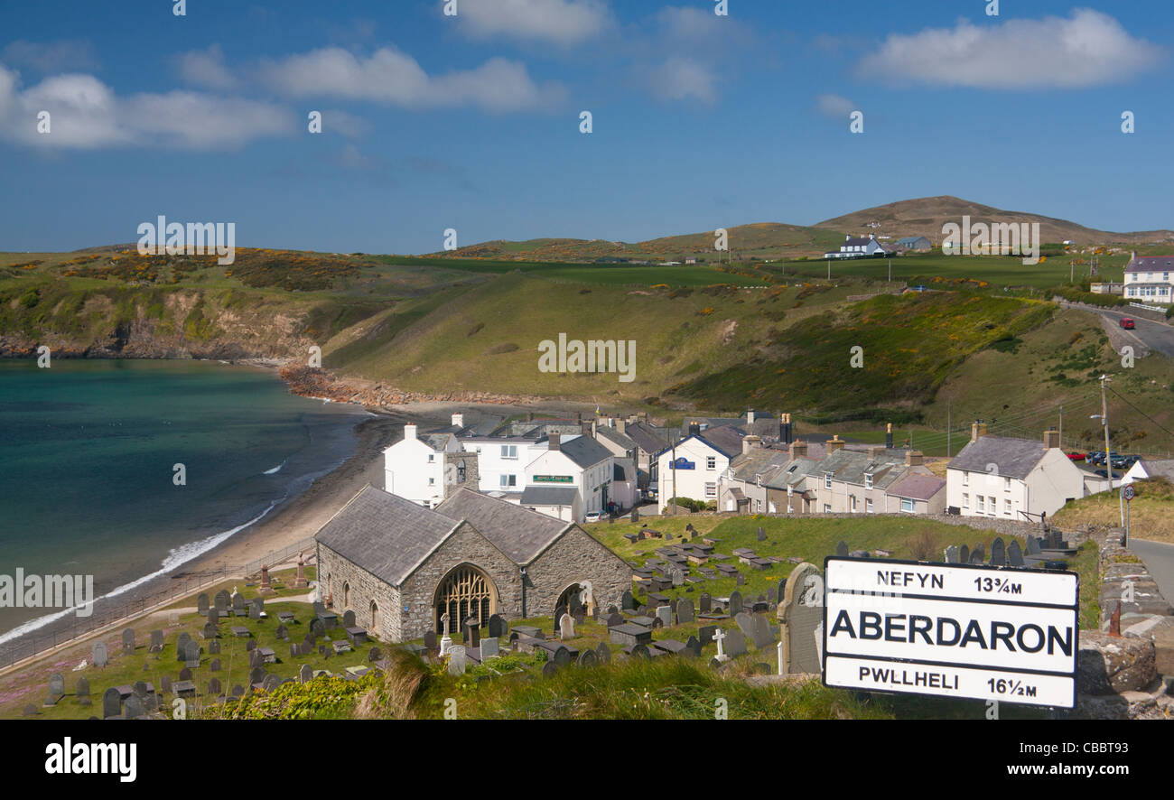 General view of Aberdaron village including St Hywyn's Church, beach and village sign Llyn Peninsula Gwynedd North Wales UK Stock Photo