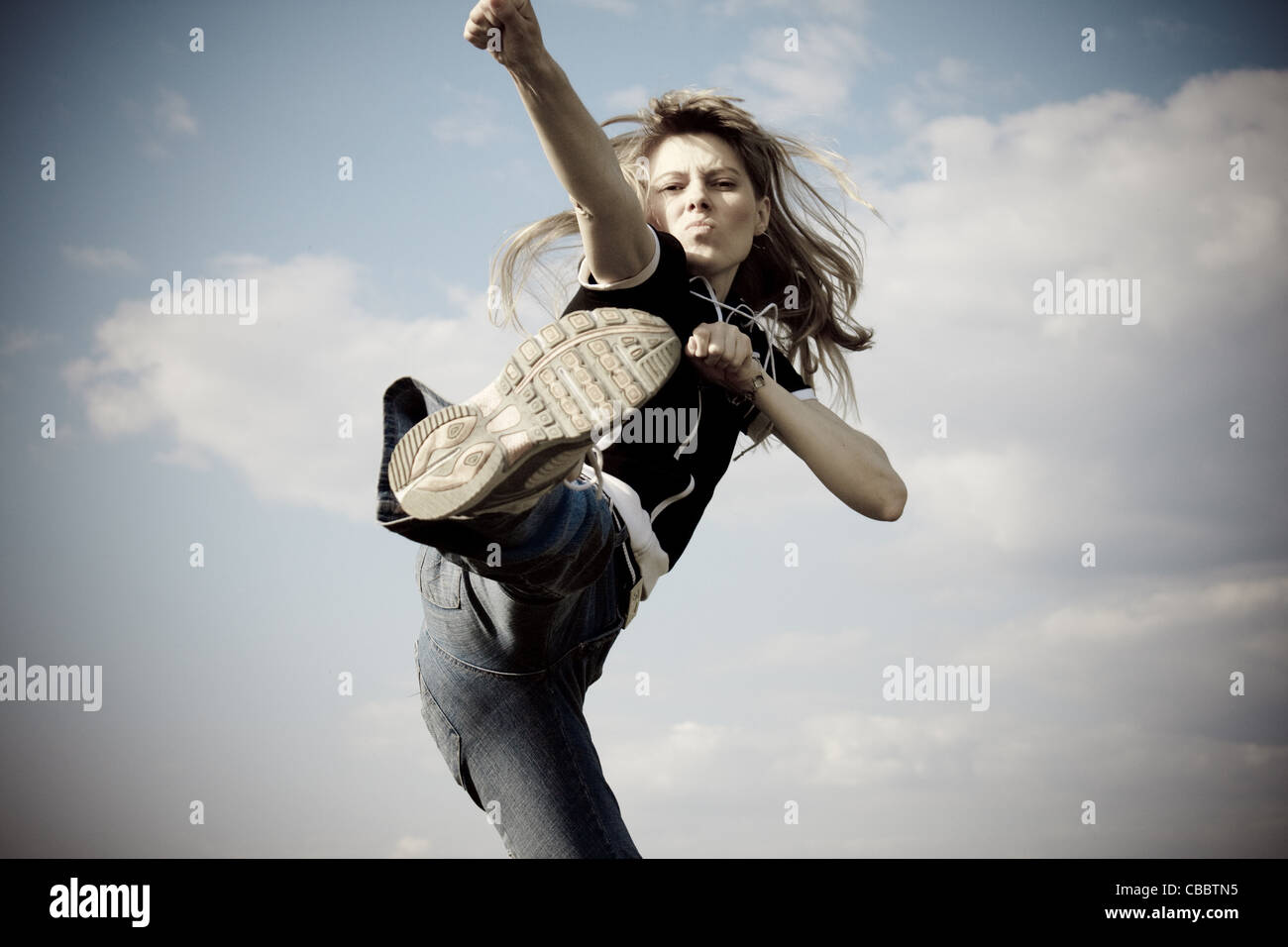 girl jumping outside with blue sky in background Stock Photo - Alamy