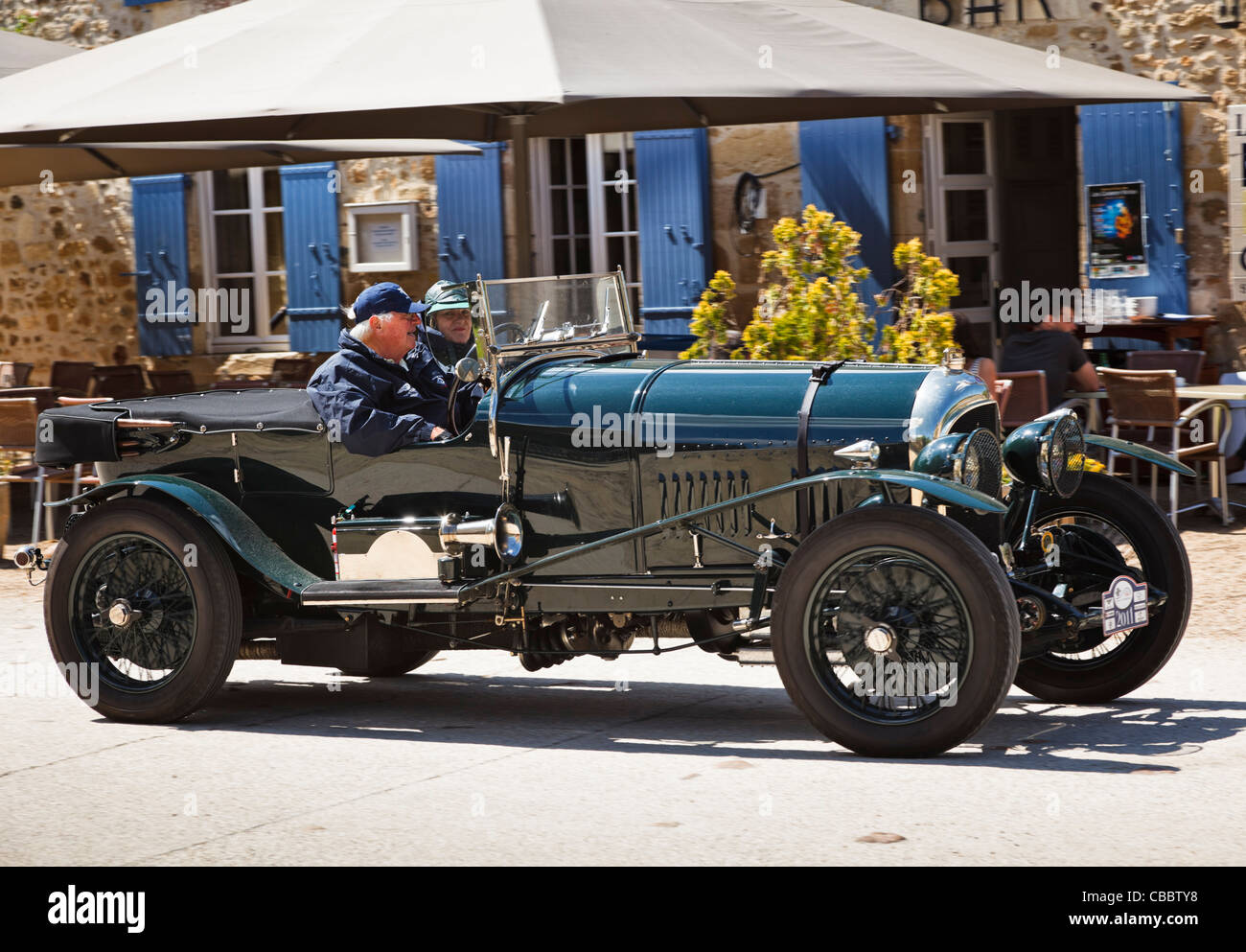 Vintage car - Bentley classic car being driven through a village in the South of France Stock Photo