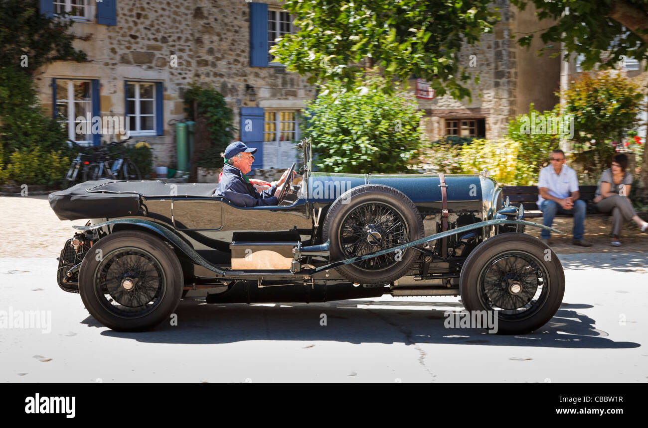 Old vintage car - vintage Bentley driving through a village in the South of France Stock Photo