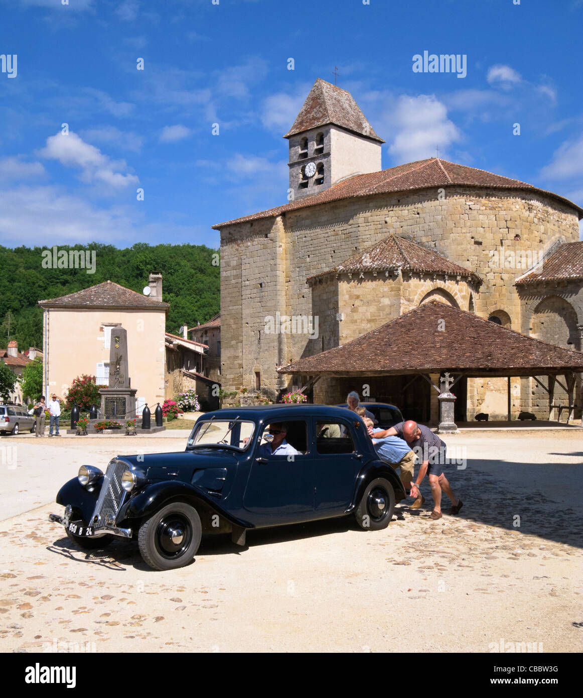 People pushing a Vintage Bentley classic car to bump start it in St Jean de Cole, Dordogne, France Stock Photo