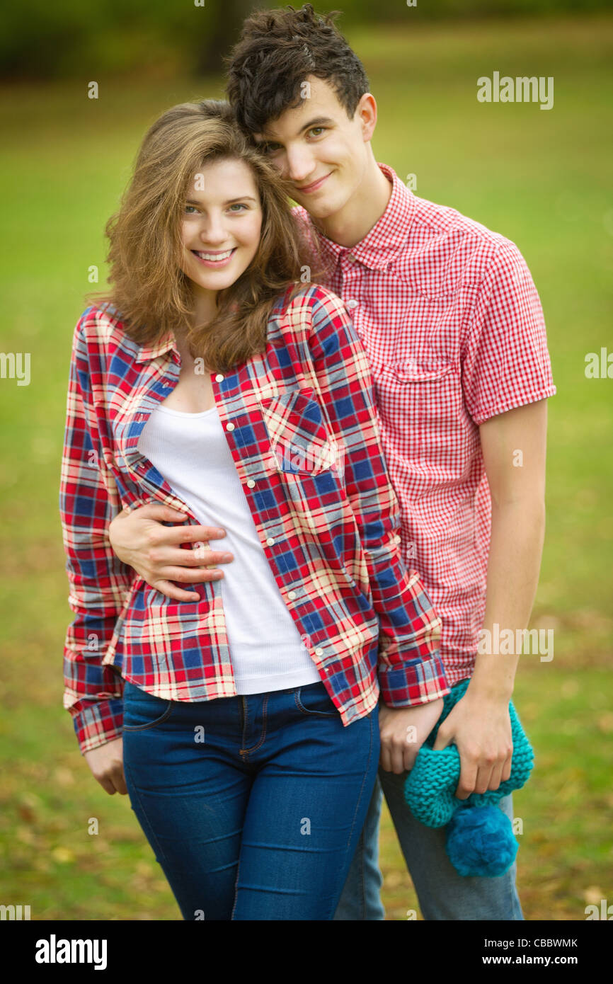 Teenage couple hugging in park Stock Photo - Alamy