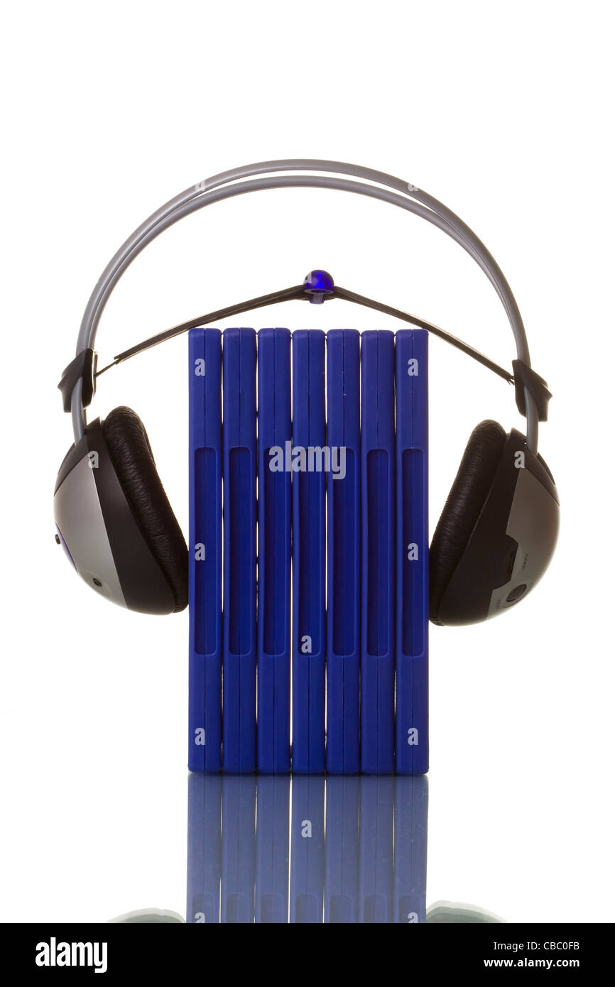 headphones holding blue dvd cases isolated in white with reflection Stock Photo
