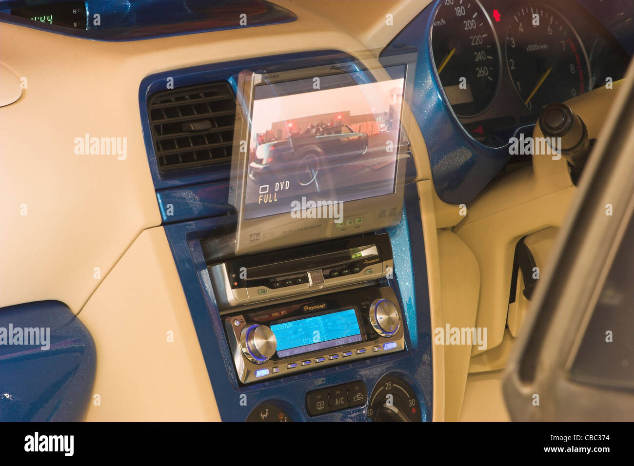 Time exposure to show movement of a dedicated in-vehicle television screen moving into position. Stock Photo