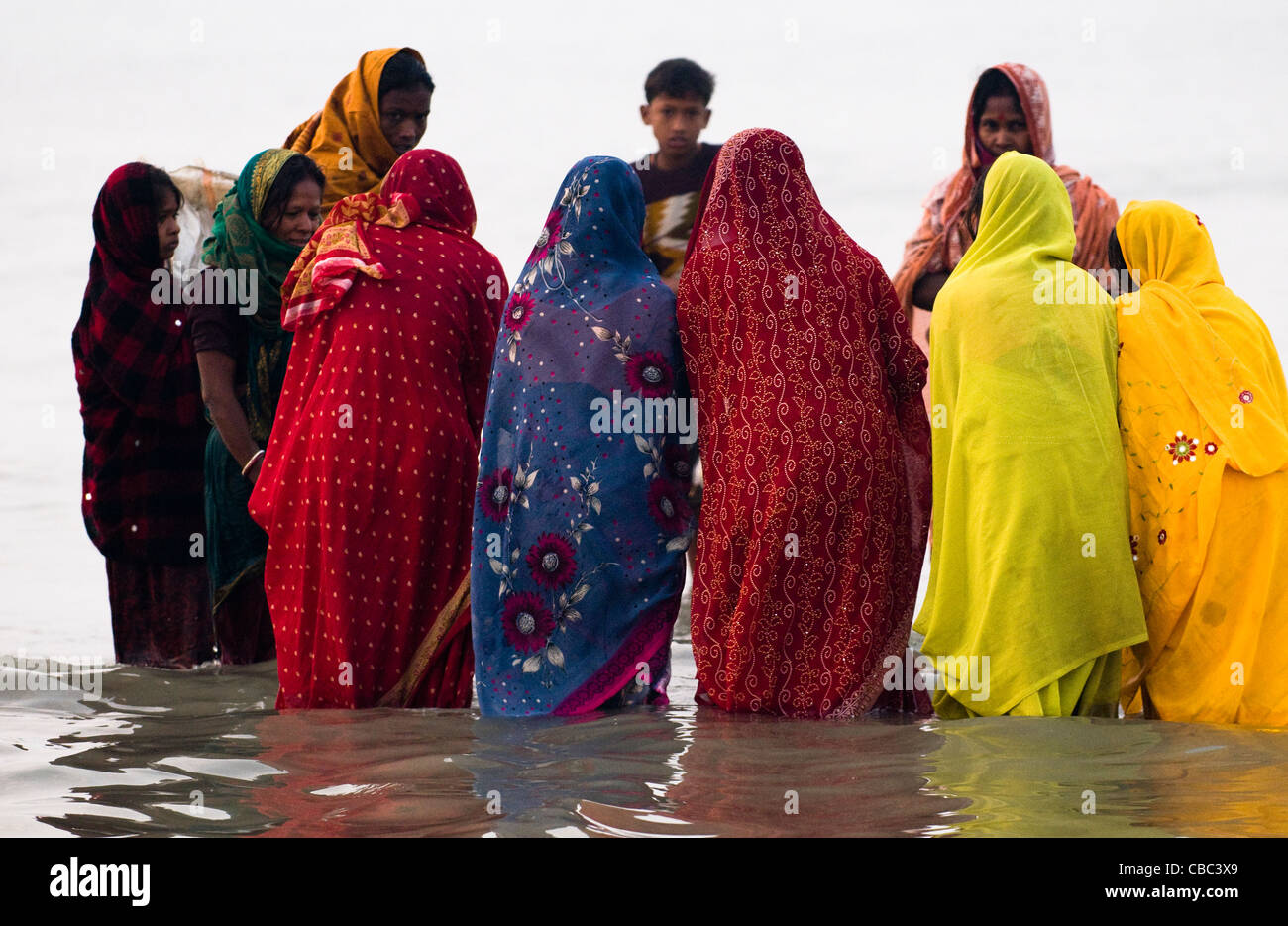 Indian women perform a puja by the holy Ganga water at Gangasagar. Stock Photo