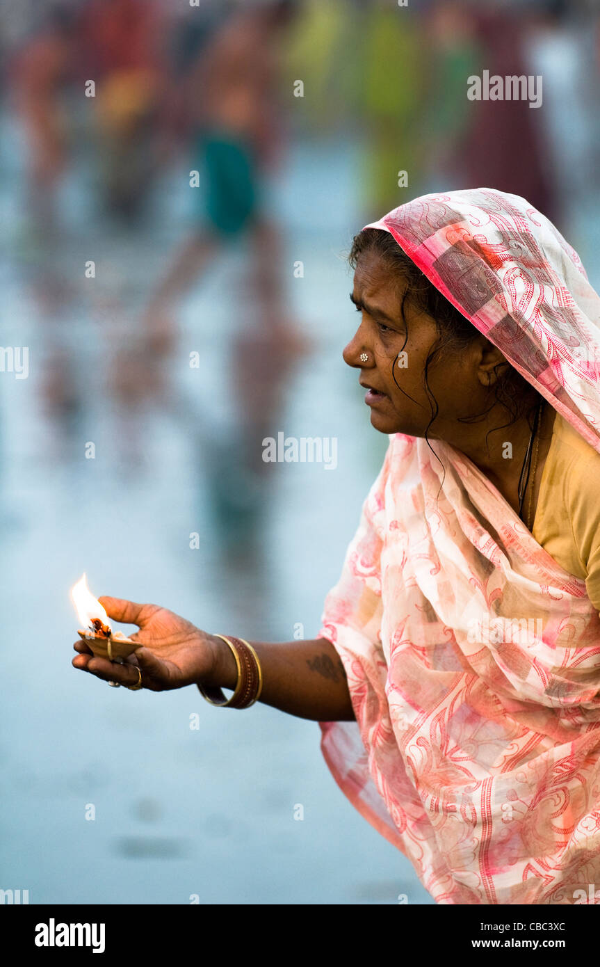 An Hindu Indian woman praying by the holy water of Gangasagar. Stock Photo