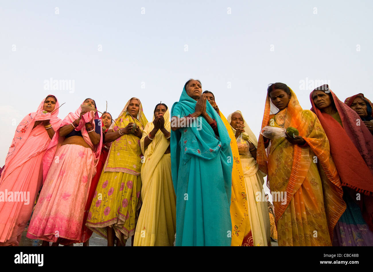 Indian women perform a puja by the holy Ganga water at Gangasagar. Stock Photo