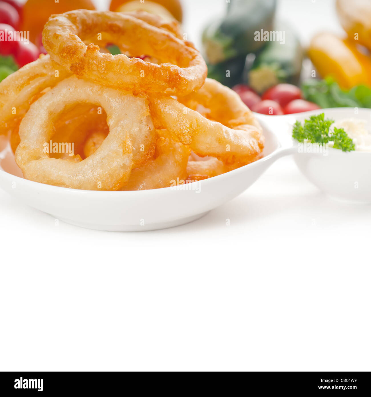 golden deep fried onion rings served with mayonnaise dip and fresh