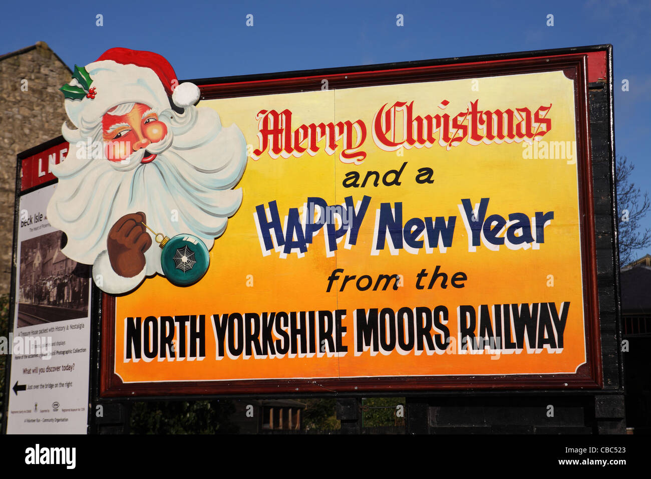 A poster or notice wishing people a Merry Christmas and a Happy New Year, North Yorkshire Moors Railway. Pickering UK Stock Photo