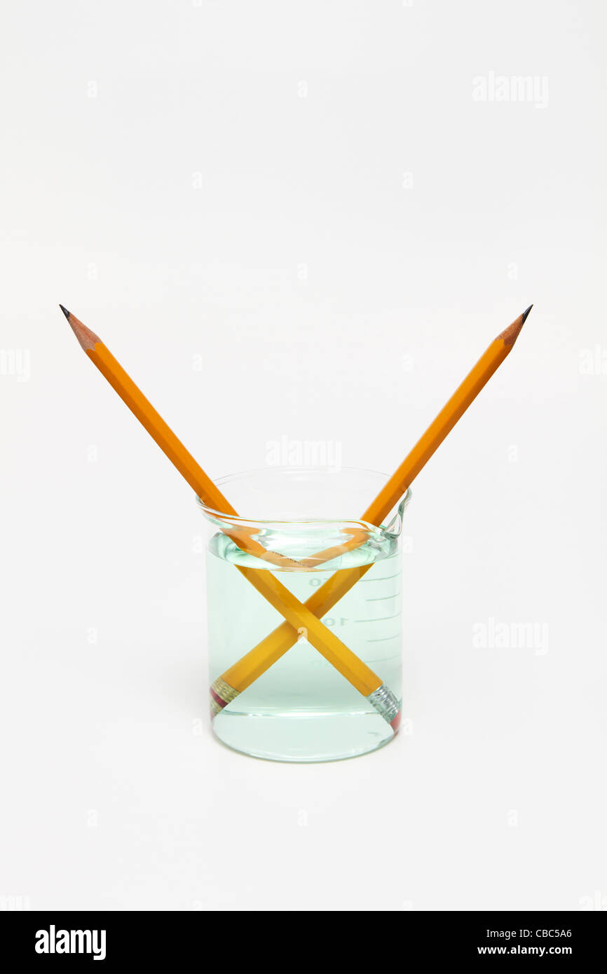 Pencils in a beaker with water Stock Photo