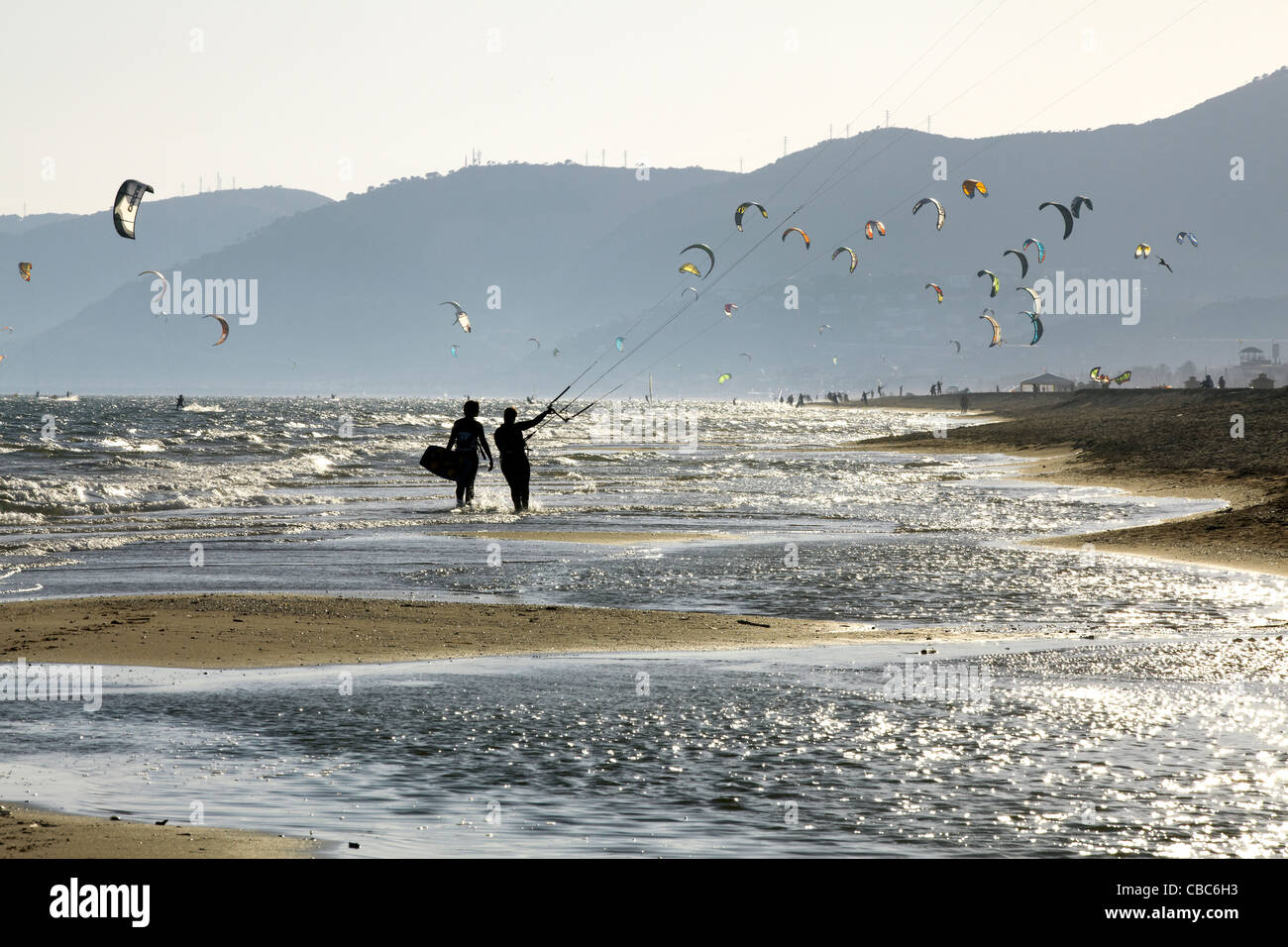 Couple flying kites on beach Stock Photo Alamy