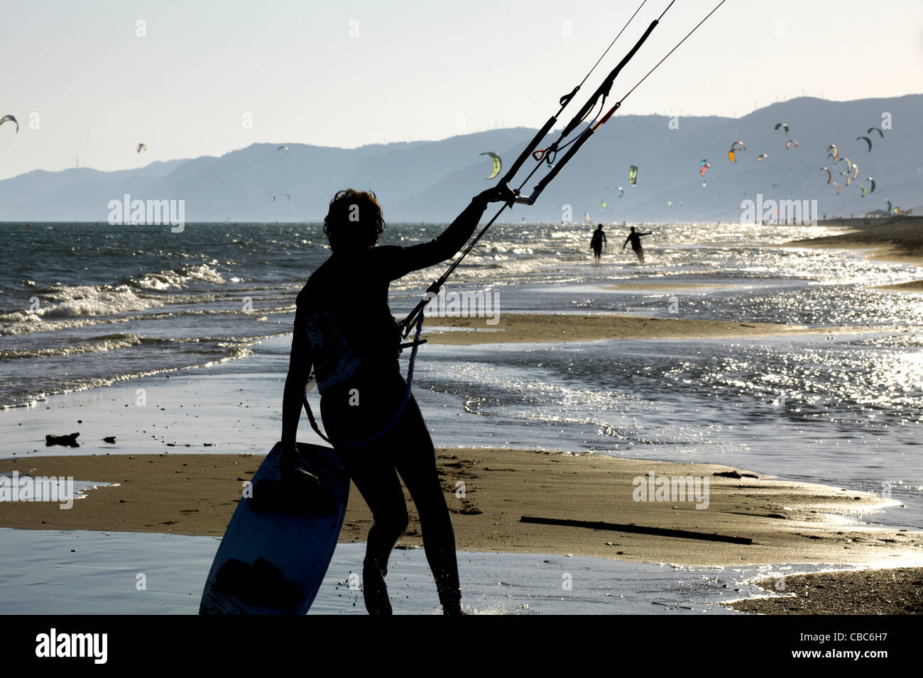 Man flying kites on beach Stock Photo Alamy