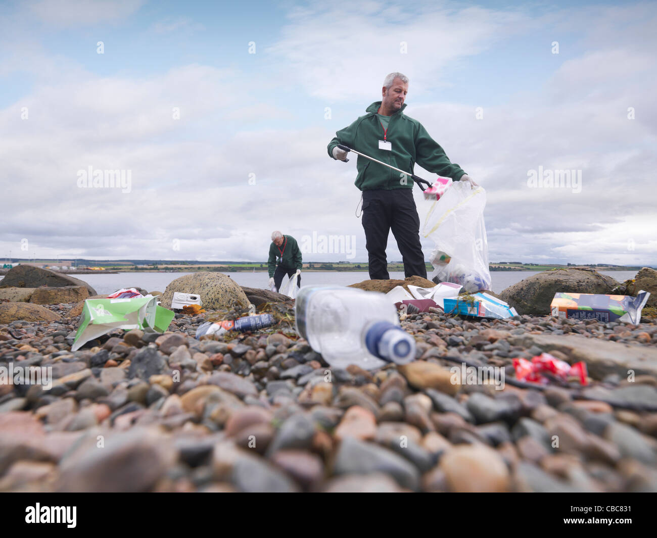 Environmentalist cleaning up beach Stock Photo