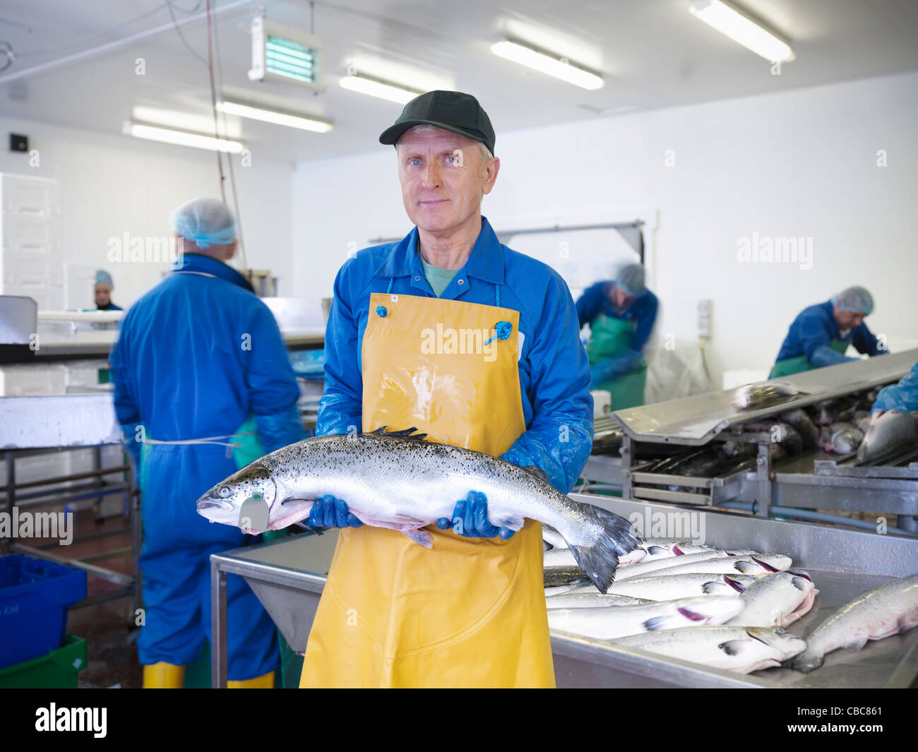 Fishmonger holding catch of the day Stock Photo