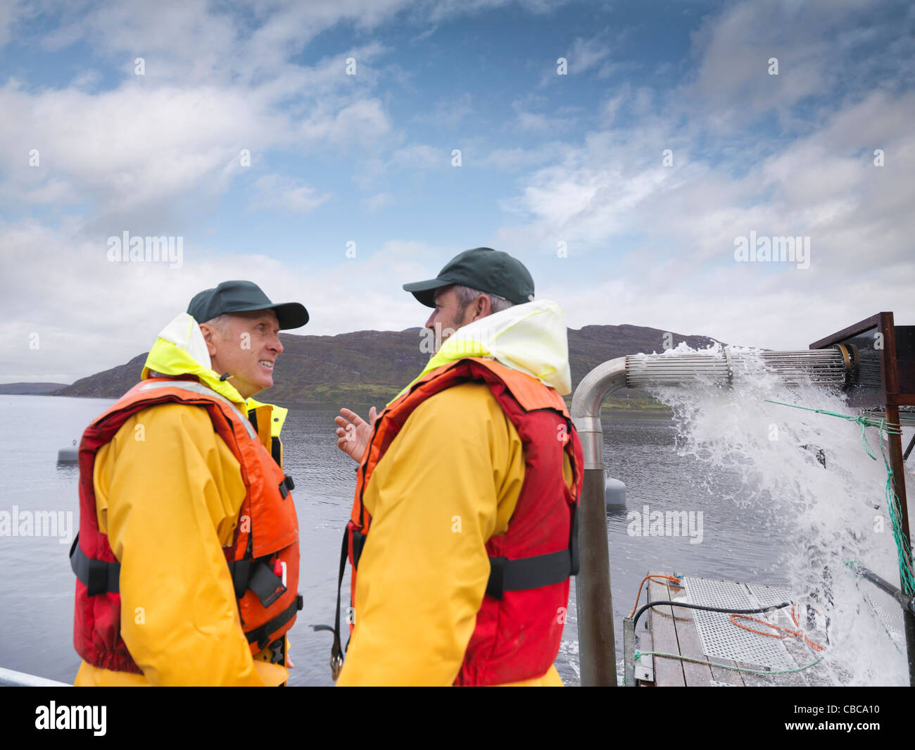 Fishermen talking on boat Stock Photo