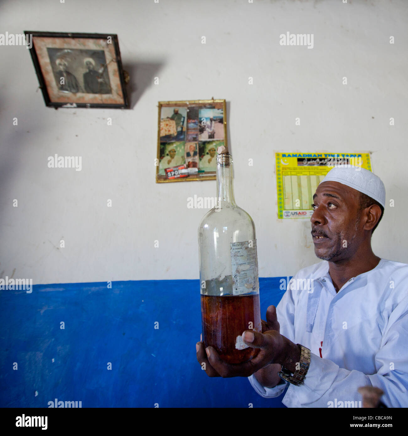 Witch Doctor Holding A Bottle Of Mysterious Potion, Lamu, Kenya Stock Photo