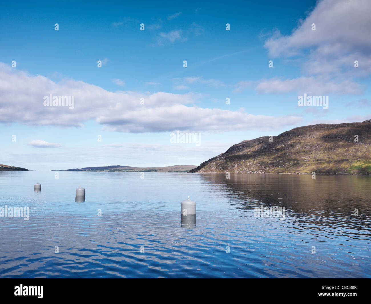 Buoys floating in still lake Stock Photo