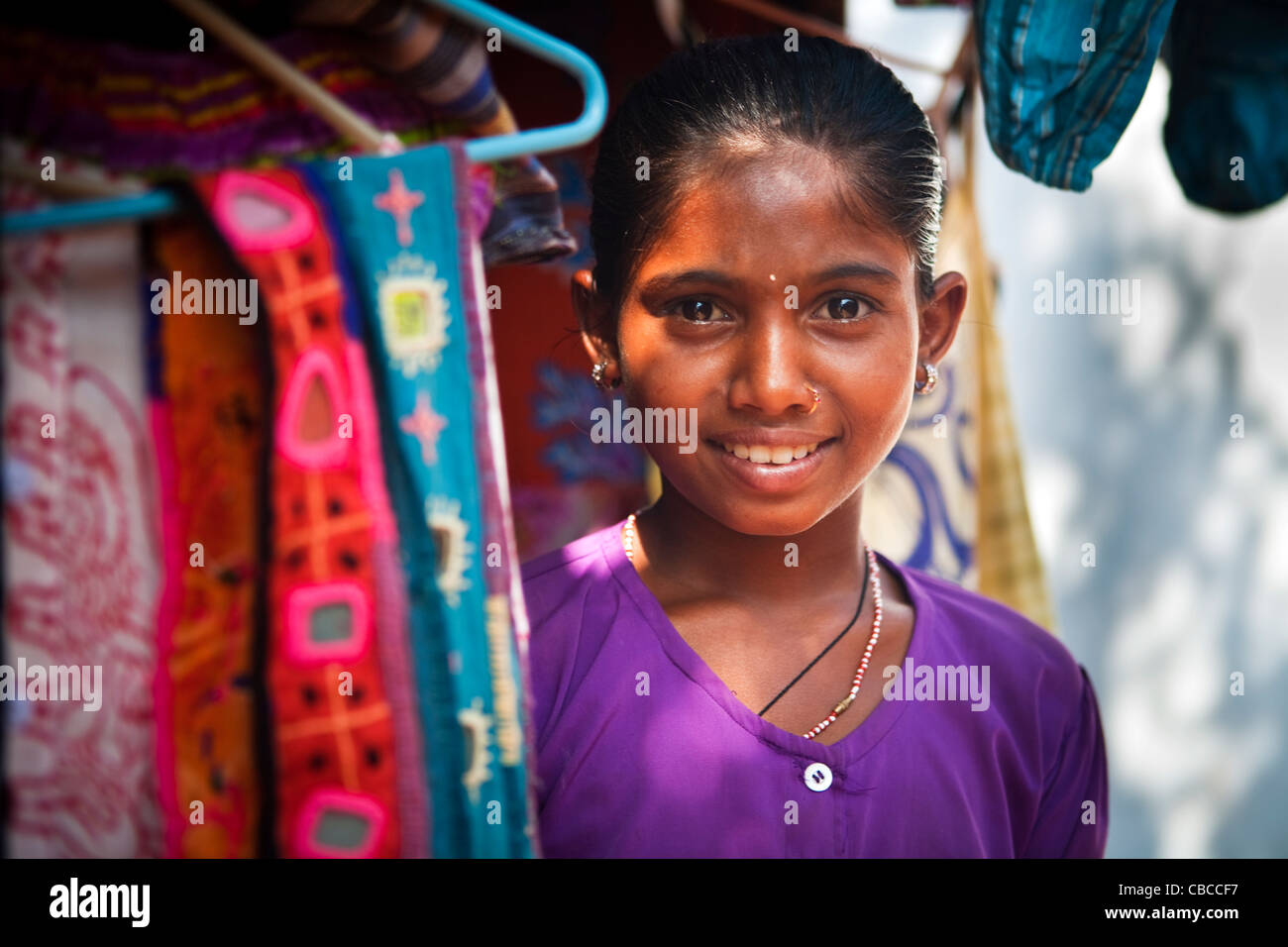 Portrait of young girl working in clothes shop, Anjuna Beach, North Goa