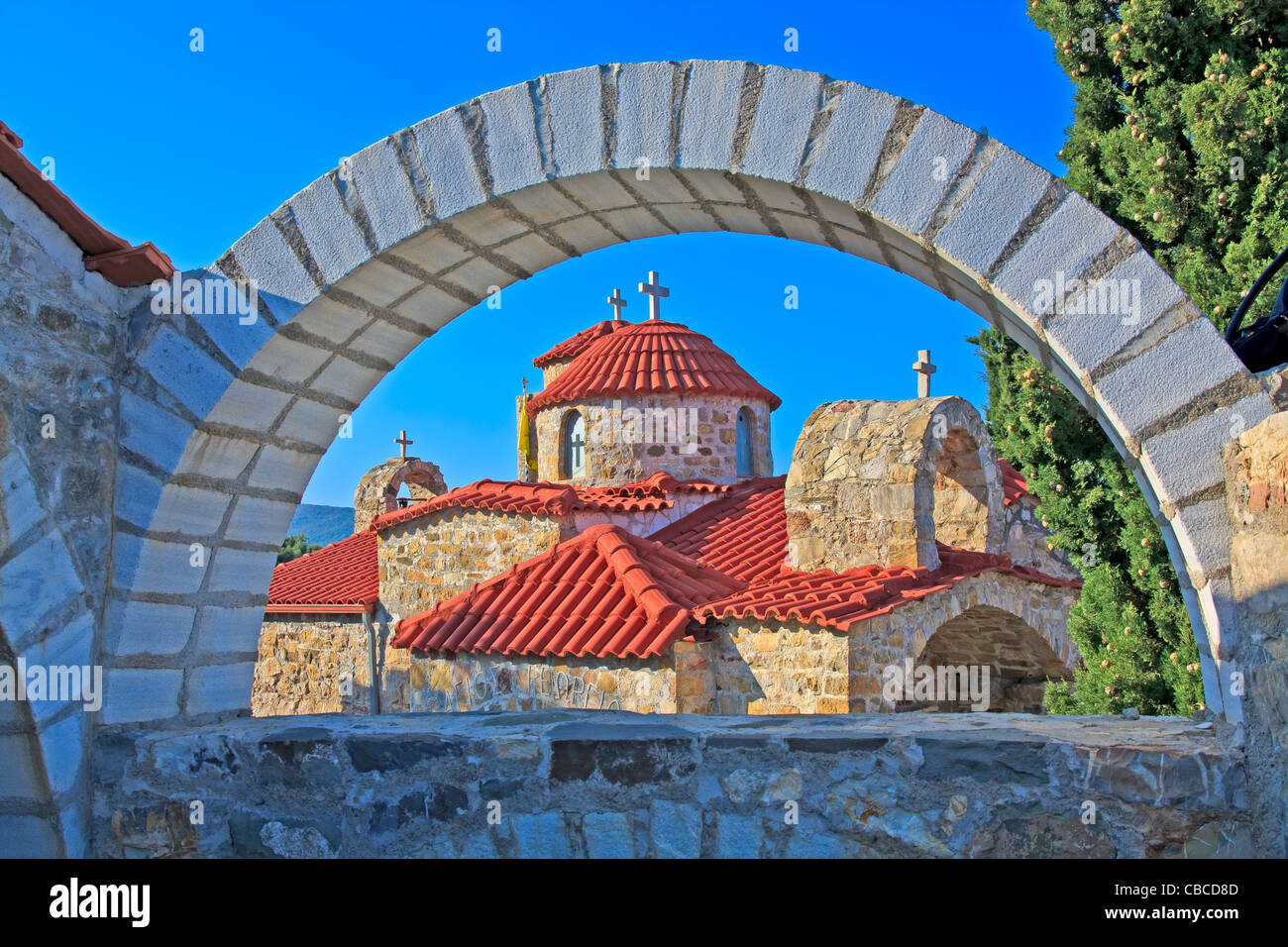 Typical stone church in Messinia, Greece framed through an arc Stock Photo