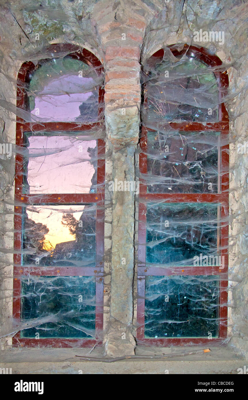 Old window and spiderwebs in abandoned house Stock Photo