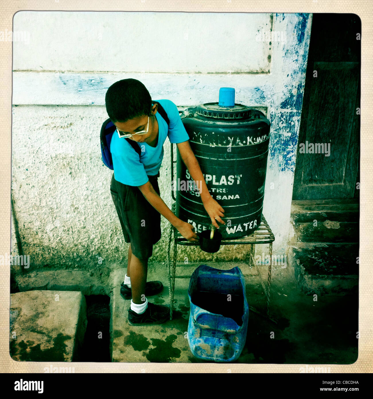 A Child Is Taking Drinkable Water From A Public Container, Lamu, Kenya Stock Photo