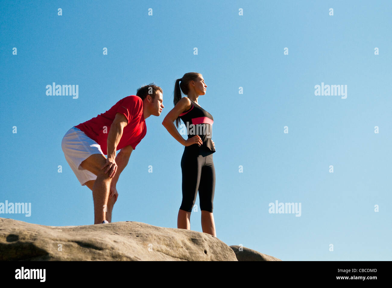 Rock climbers standing on boulder Stock Photo