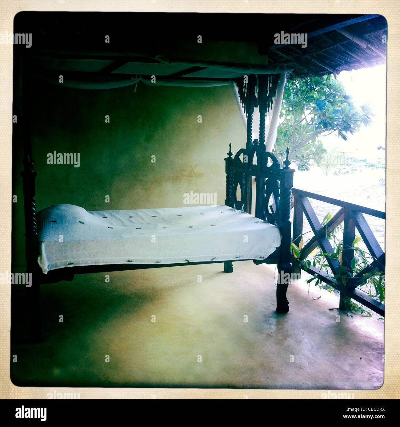 A Carved Wood Bed With Mosquito Net On A Lamu Wealthy House's Balcony, Lamu, Kenya Stock Photo