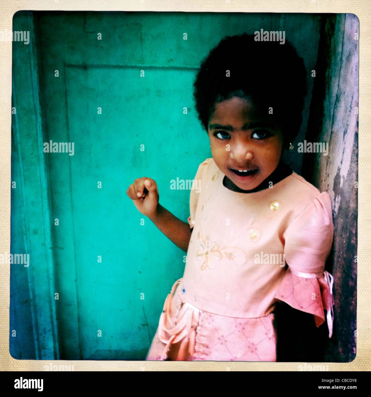 Little Girl In A Pink Dress With Short Hair In A Corner Lamu