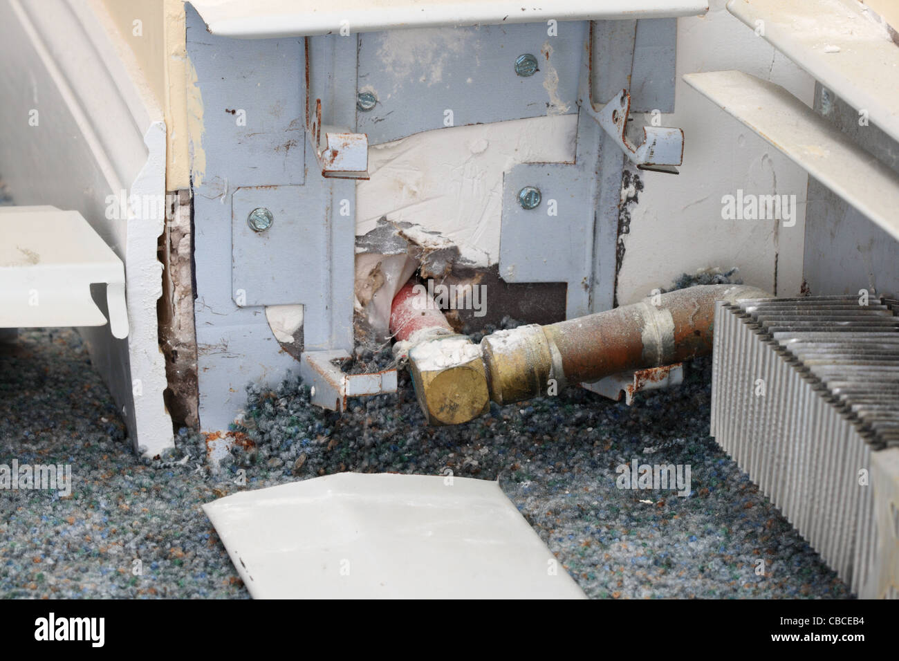 exposed baseboard heater heating pipe during home repair Stock Photo