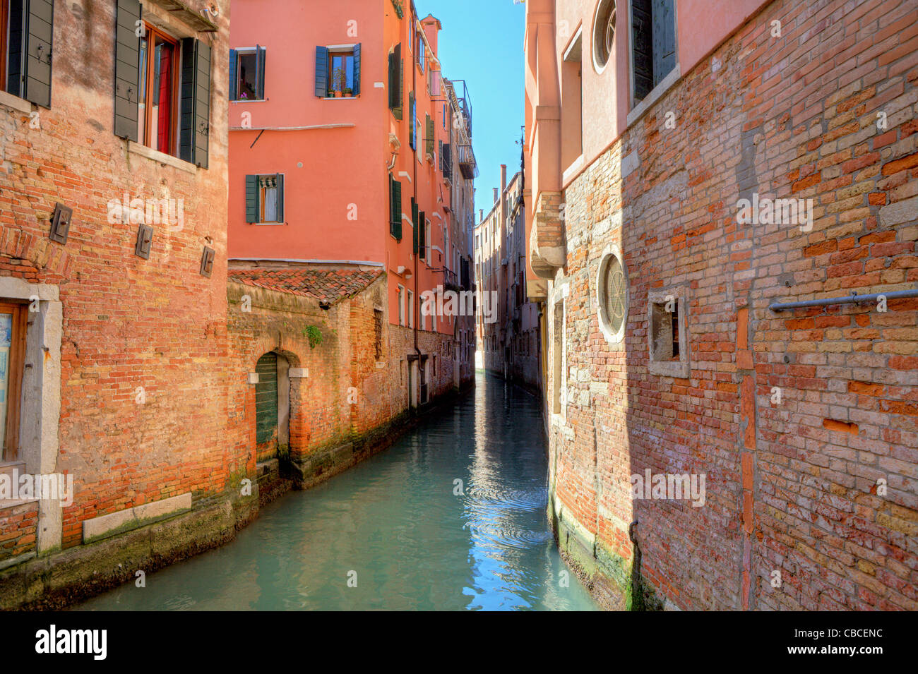 Narrow canal among old colorful houses in Venice, Italy Stock Photo - Alamy