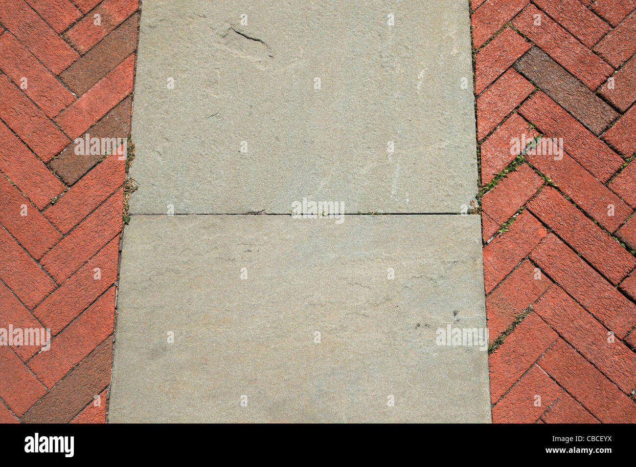 red herringbone brick and gray sand stone walkway detail Stock Photo