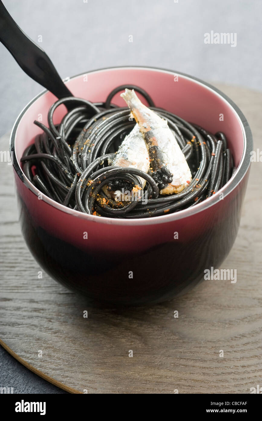 Black spaghetti with sardines and Espelette pepper Stock Photo