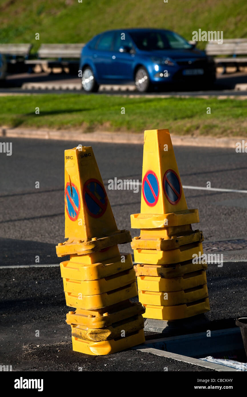 Two stacks of no parking cones on a roadside Stock Photo