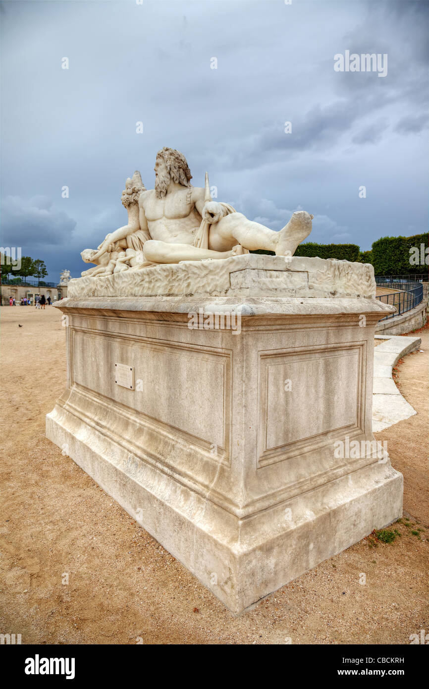 Sculpture in Tuileries gardens and dramatic sky in background, Paris, France. Stock Photo