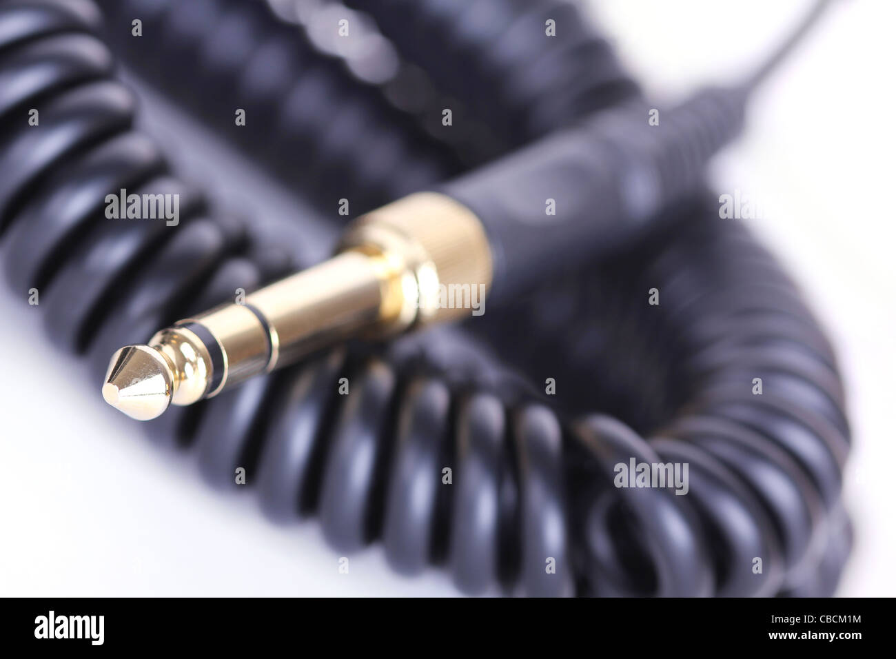 Spiral Dj headphones cable, closeup on white Stock Photo Alamy