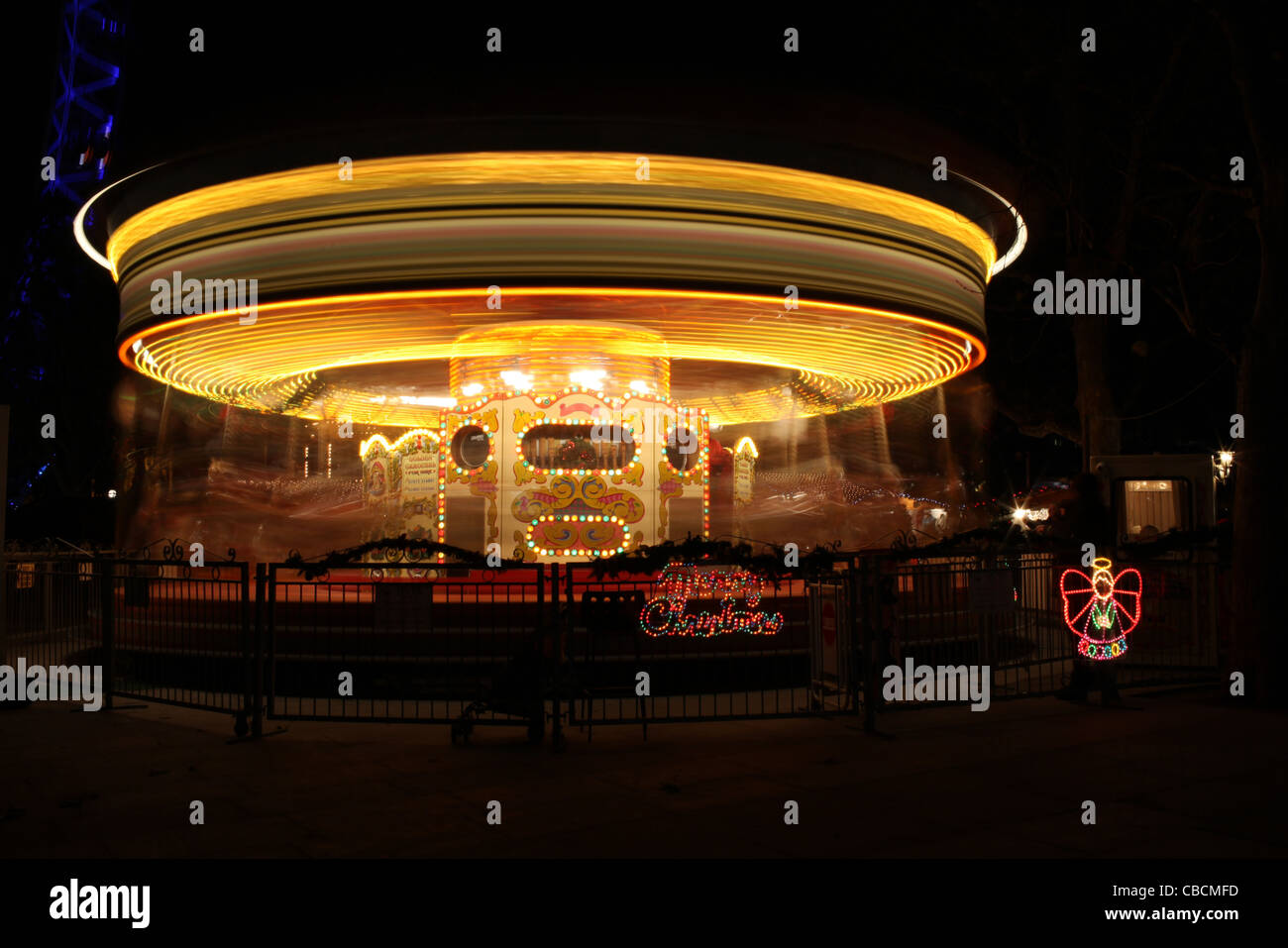Long exposure of carousel/merry-go-round at night with lights Stock Photo