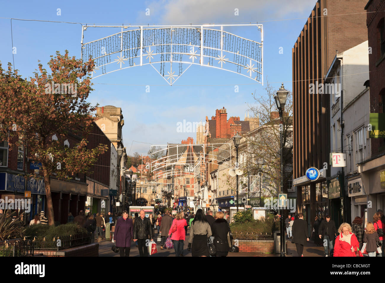 High Street Lincoln Lincolnshire England UK Christmas shoppers shopping in busy city centre shops Stock Photo