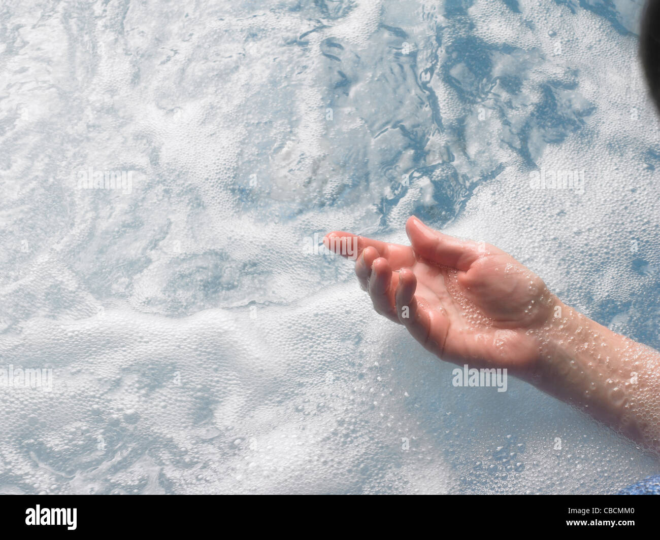 Female hand in spa water Stock Photo
