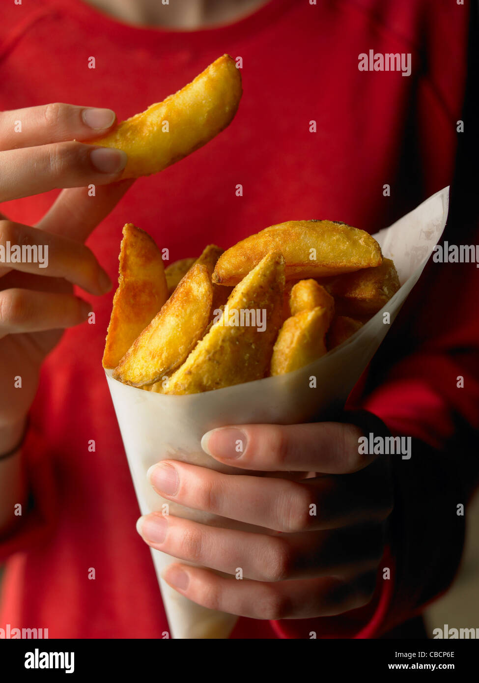 Potato Wedge Chips in Ladies Hands Stock Photo