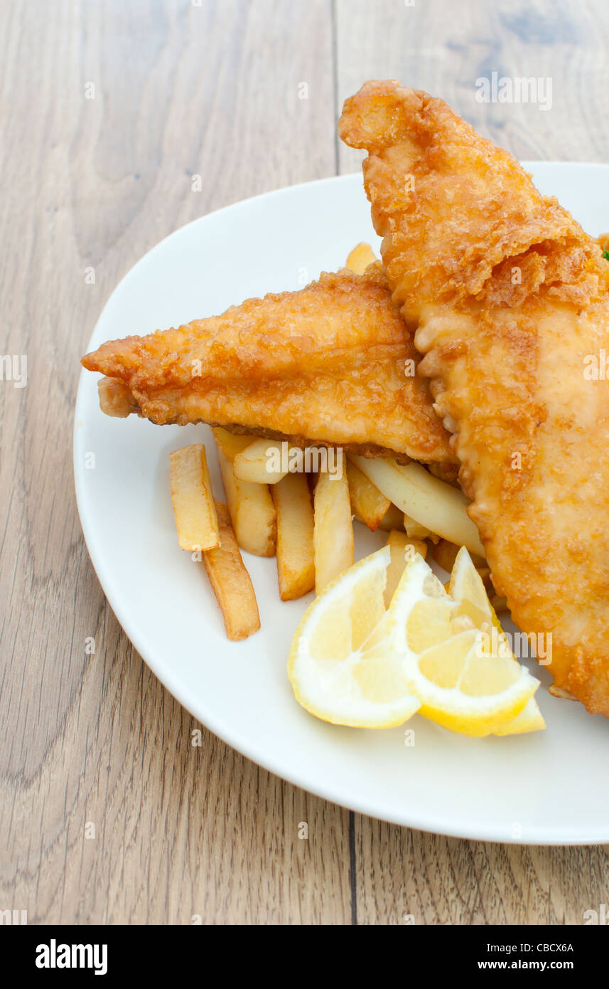 Side view of a plate of fried fish fillets with chips Stock Photo