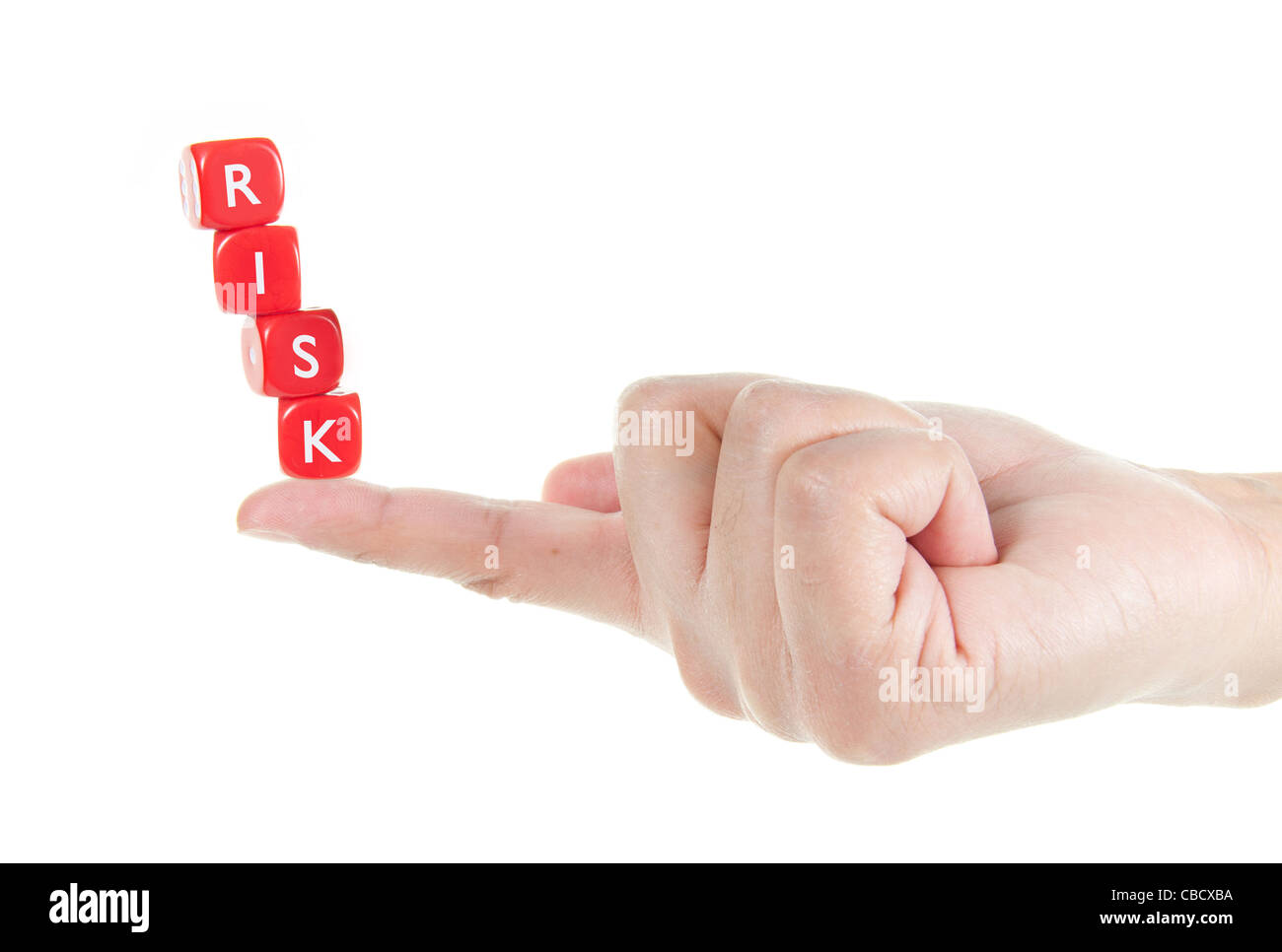 Dice labelled risk balanced on a finger tip Stock Photo