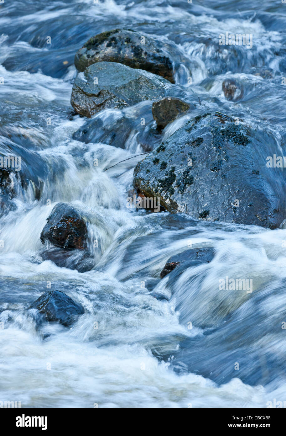 Fast flowing river with rocks Stock Photo - Alamy