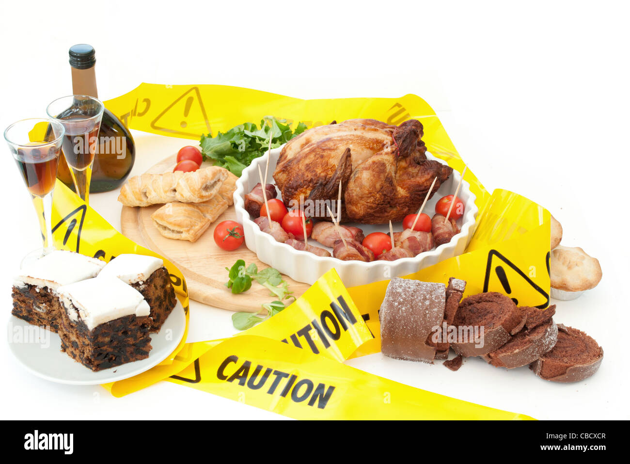 Caution warning tape around typical christmas foods Stock Photo