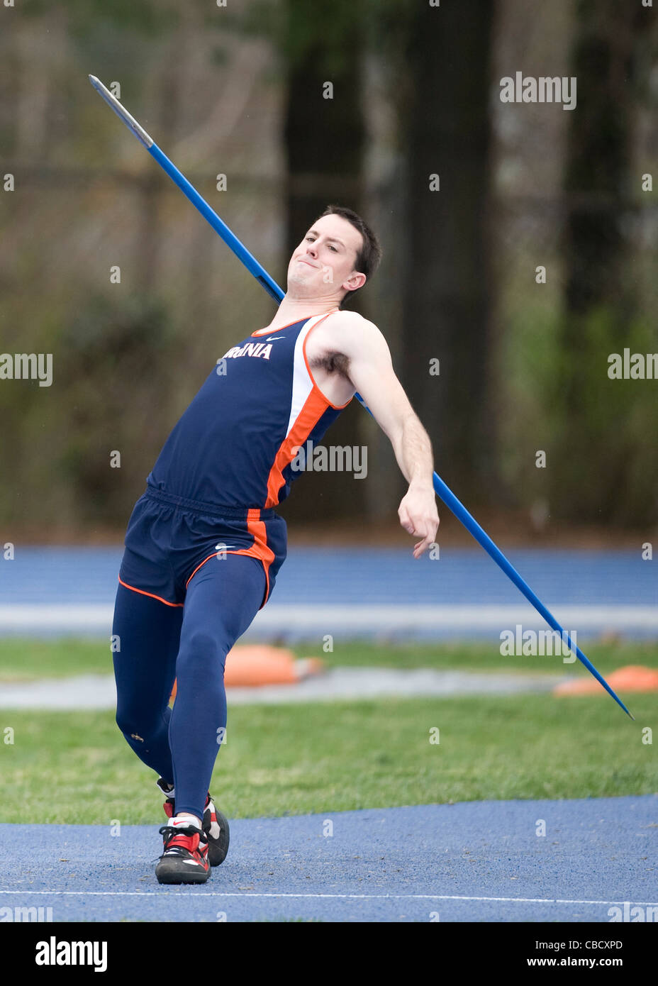 A male javelin thrower during a college track and field meet Stock
