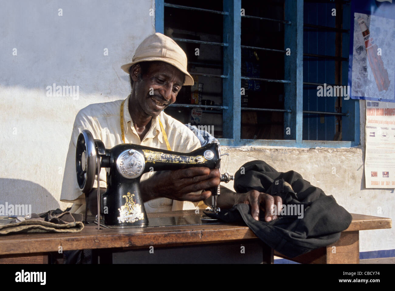 Tailor working infront of a kiosk, Boma Ngombe, Kilimanjaro Region Tanzania Stock Photo
