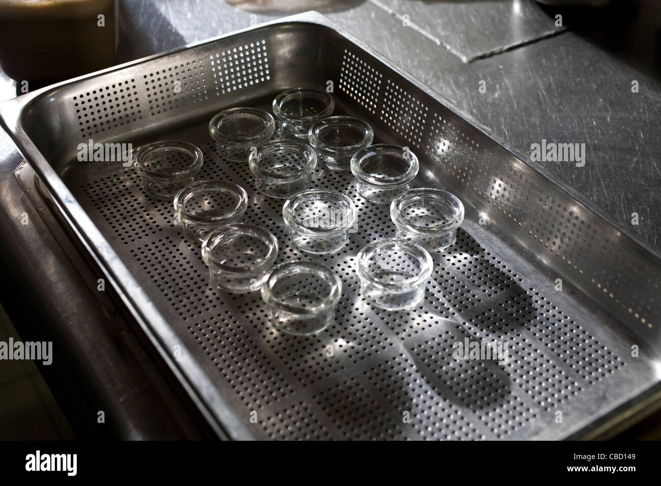 Clean glass ramekins in metal tray Stock Photo