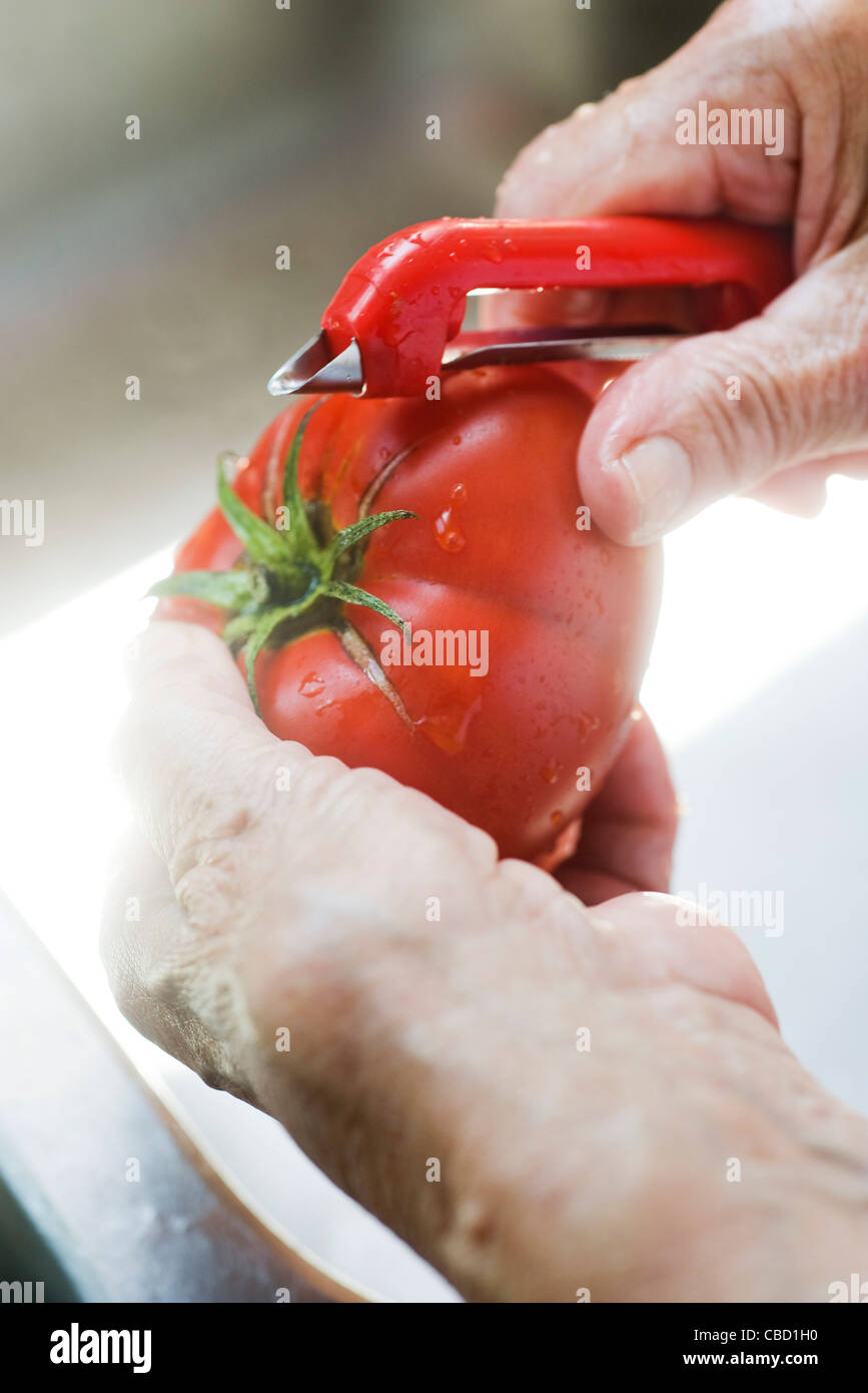 Peeling a fresh tomato Stock Photo Alamy