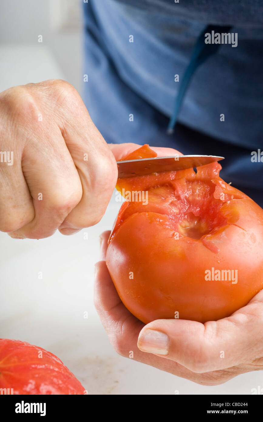 Peeling a fresh tomato Stock Photo Alamy