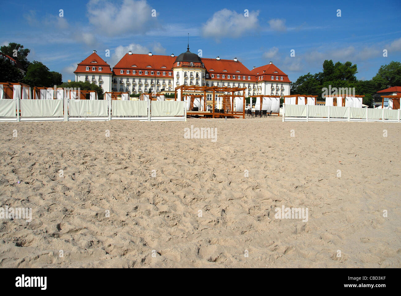 The majestic Grand Hotel at Sopot on the Baltic Sea coast near Gdansk seen from the beach and the hotel's summer club Stock Photo