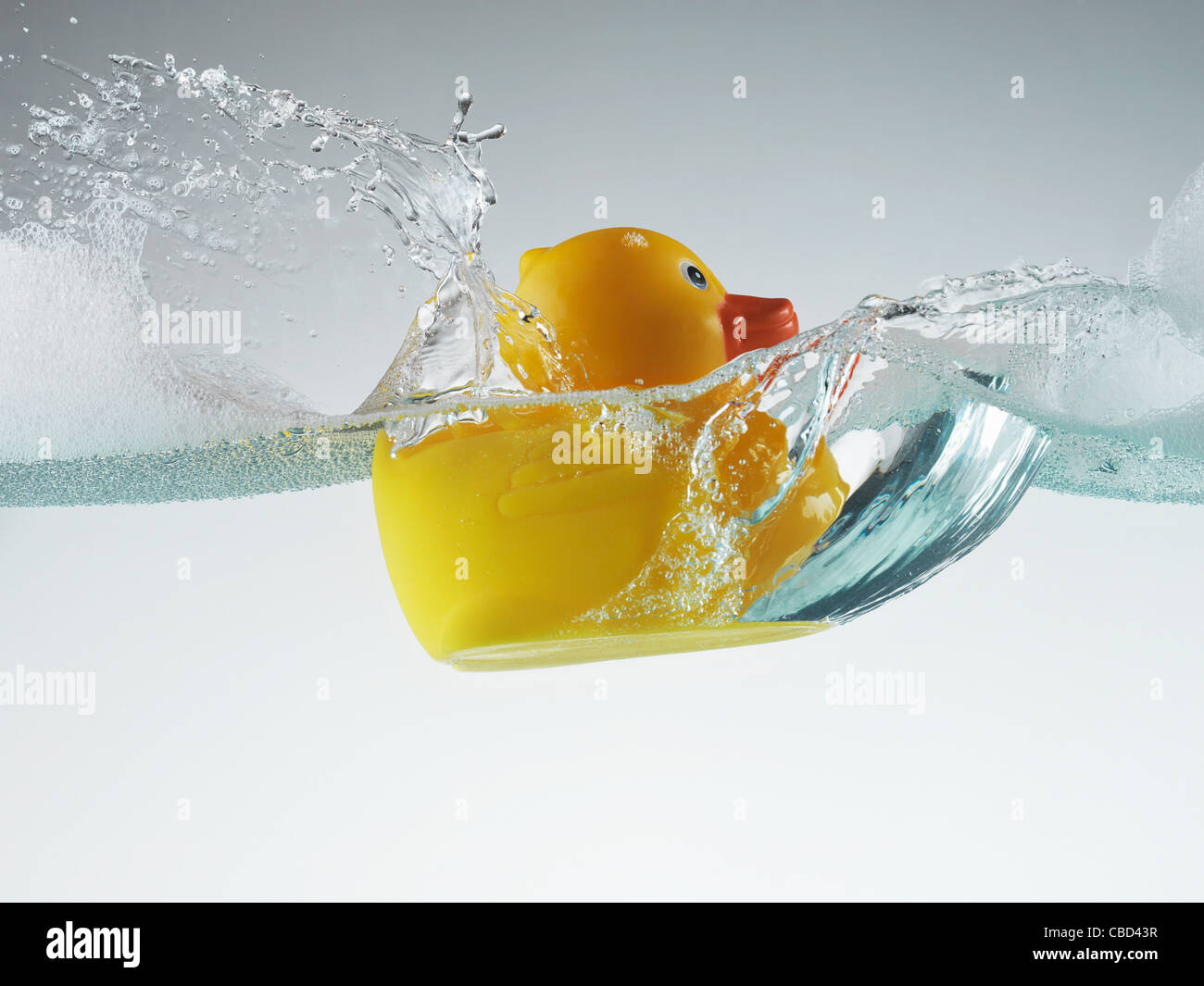 Rubber duck floating in soapy water Stock Photo